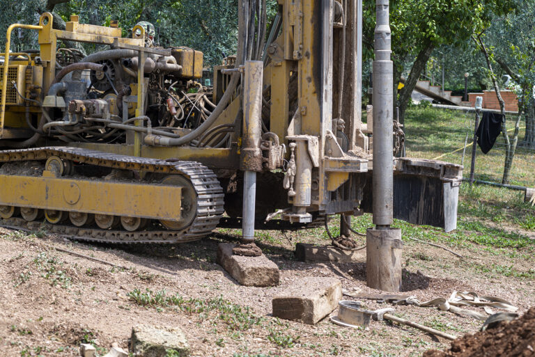 An auger tractor digging the ground at a domestic construction site